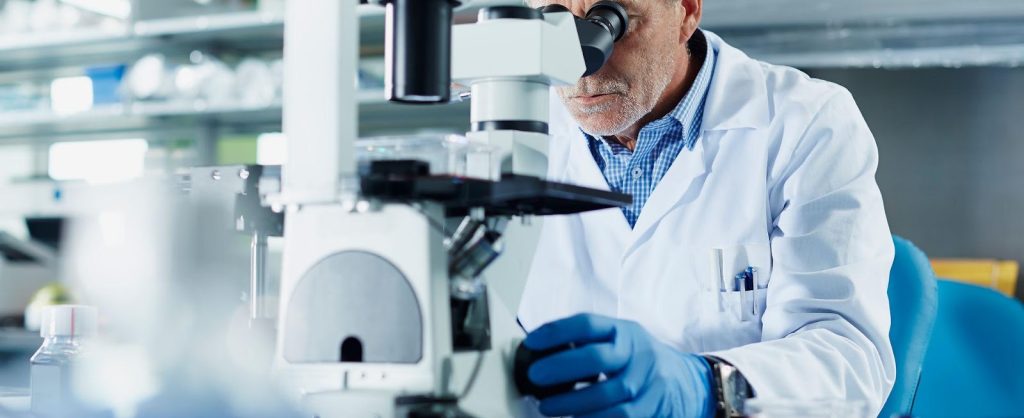 Scientist at a microscope in a laboratory