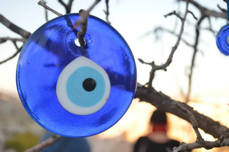 A blue glass nazar bead hanging outdoors in Cappadocia, Turkey