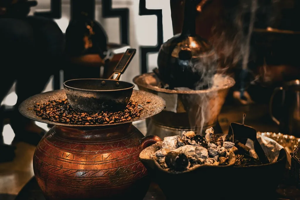 Incense burning on charcoal in a brazier beside a coffee ceremony