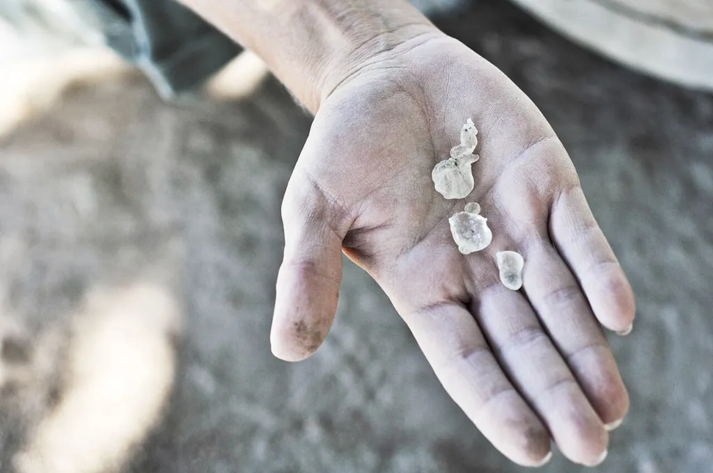 Clear mastic tears in the palm of a hand