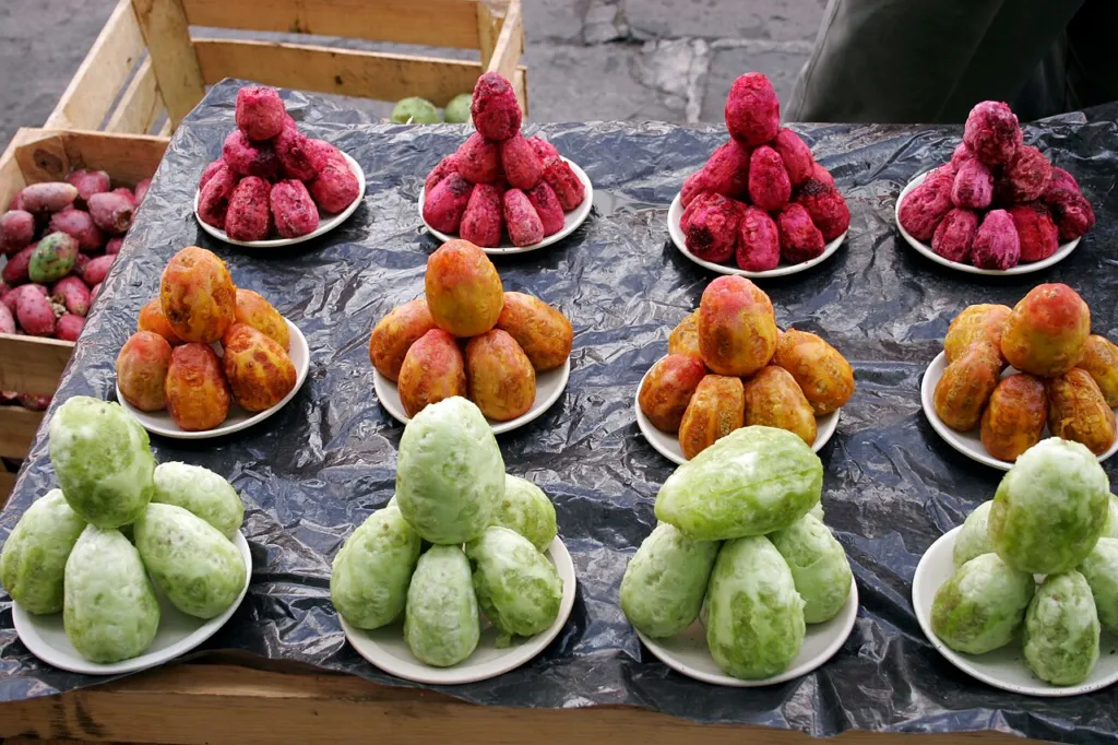 Pile of ripe red and green prickly pear fruits, Opuntia ficus-indica, at a market
