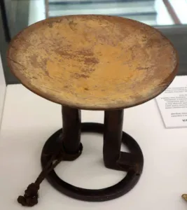 Wooden Fijian kava bowl on display in a museum case
