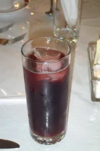 Tall glass of homemade sorrel, the Caribbean Hibiscus sabdariffa drink, with ice
