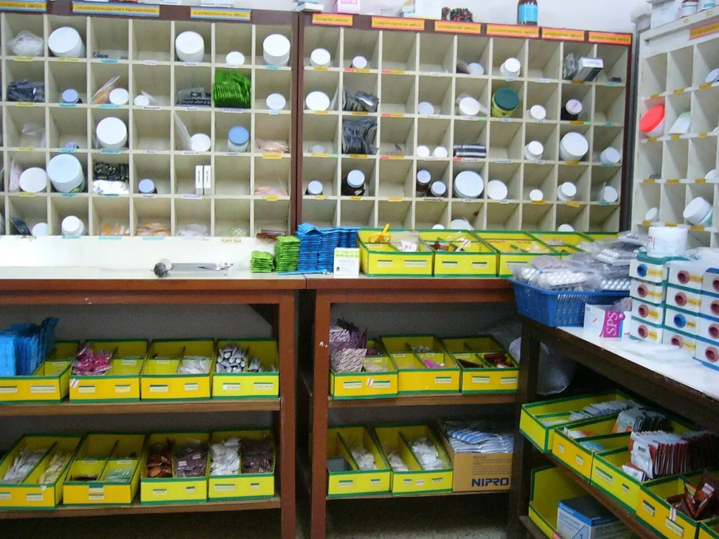Shelves of boxed medicines in a hospital pharmacy dispensary