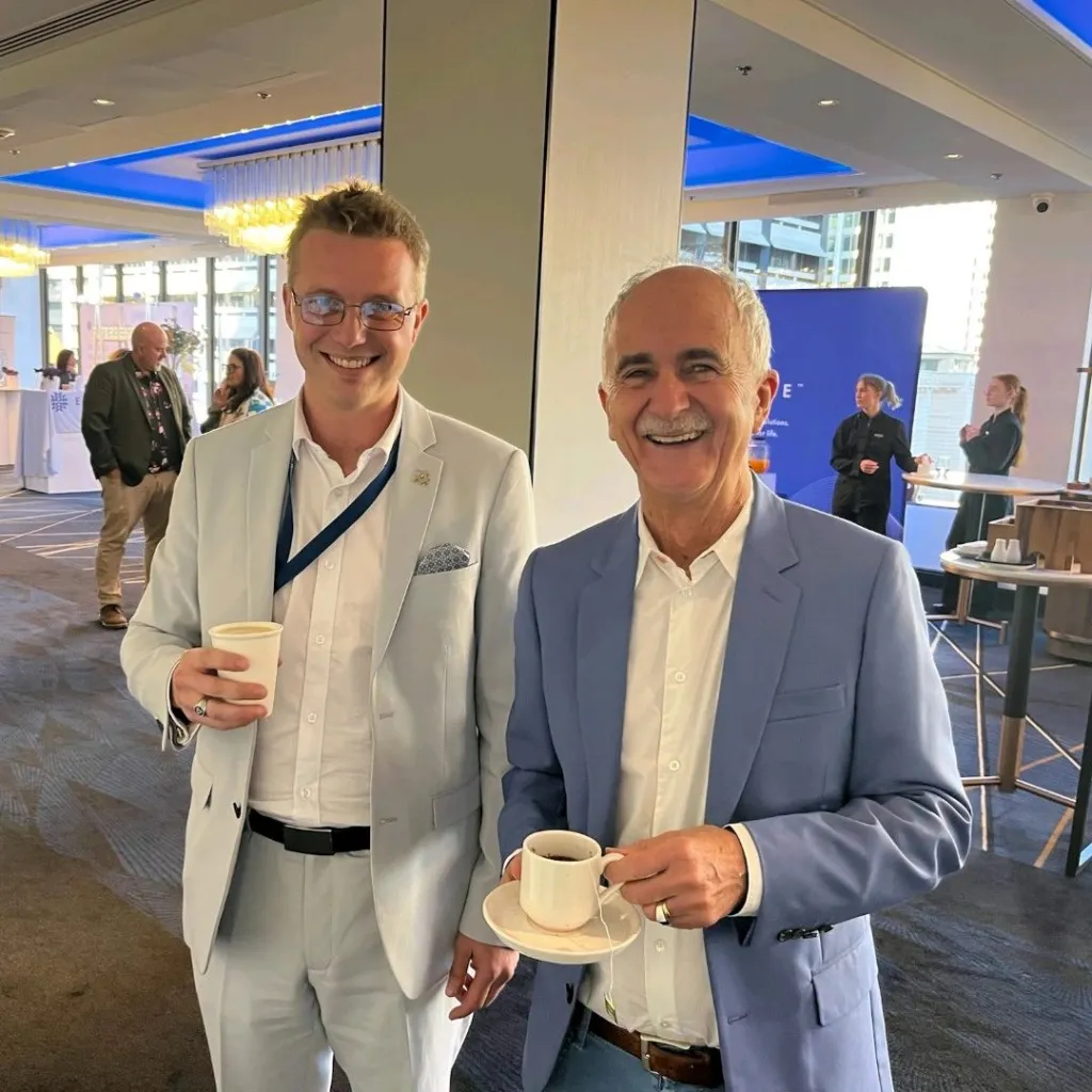 Professor Kerry Bone, right, holding a cup of tea, with Dr Luke Iggulden at a lecture event in September 2024