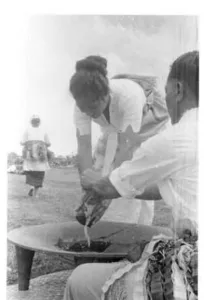 Black-and-white photograph of a kava cup being filled from a bowl at a Tongan ceremony, 1971